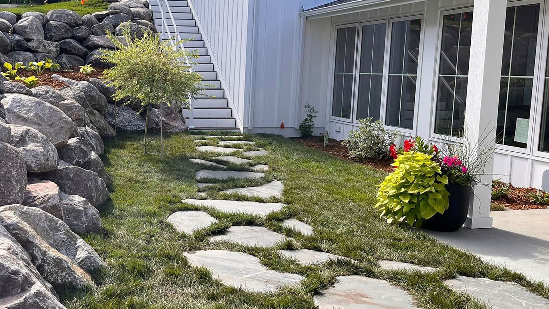 Natural stone walkway and boulder retaining wall